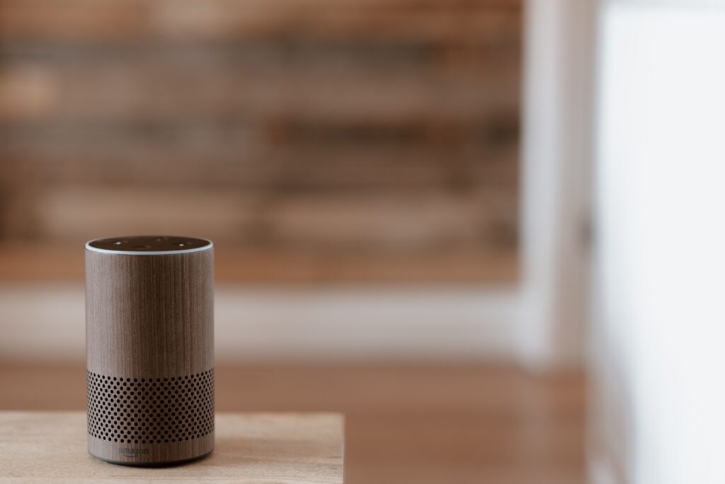 Smart speaker on a wooden table indoors.