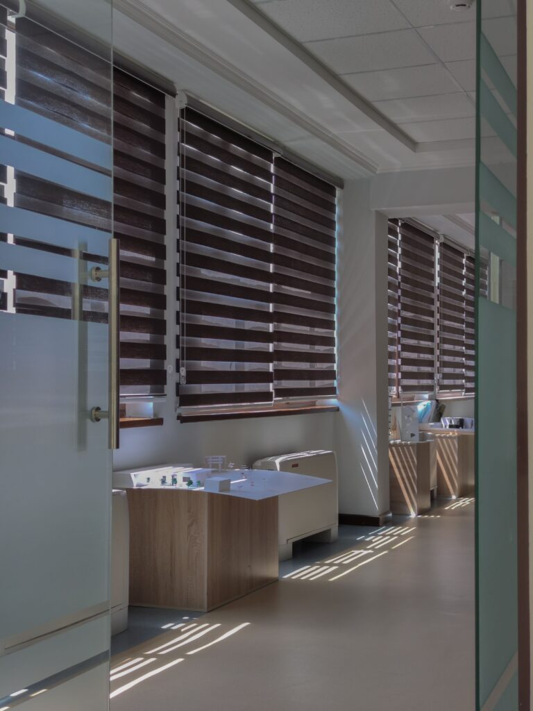 Modern office with large striped window blinds