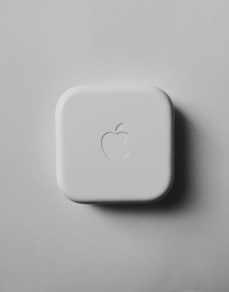 White square Apple case on gray background.
