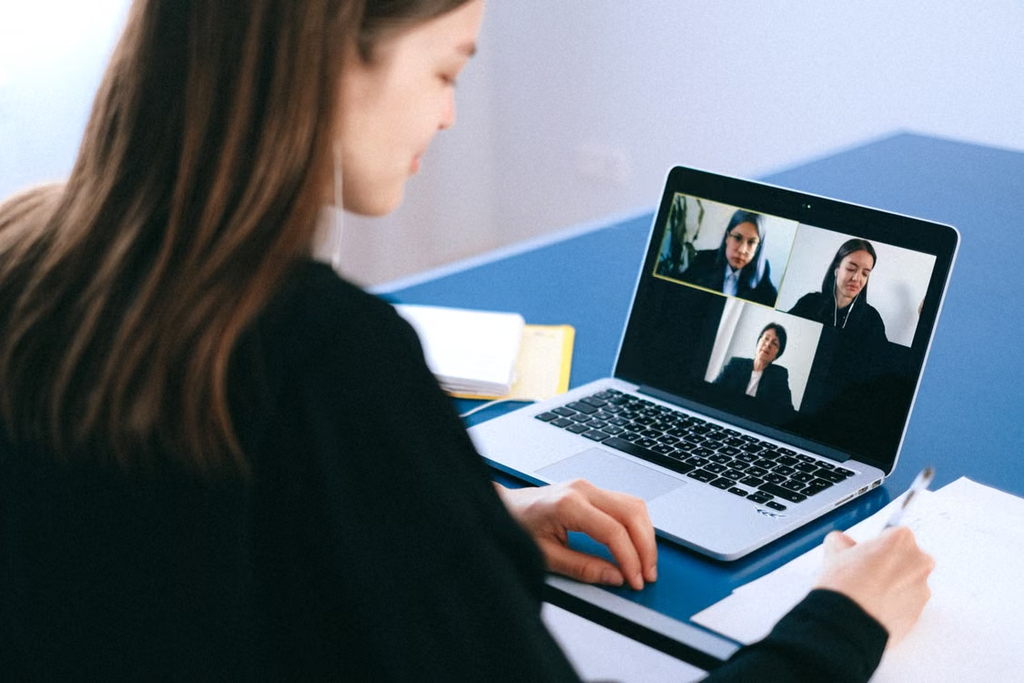Woman participating in virtual meeting on laptop