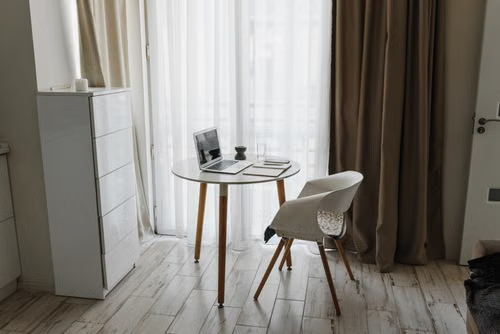 Minimalist home office with laptop and chair